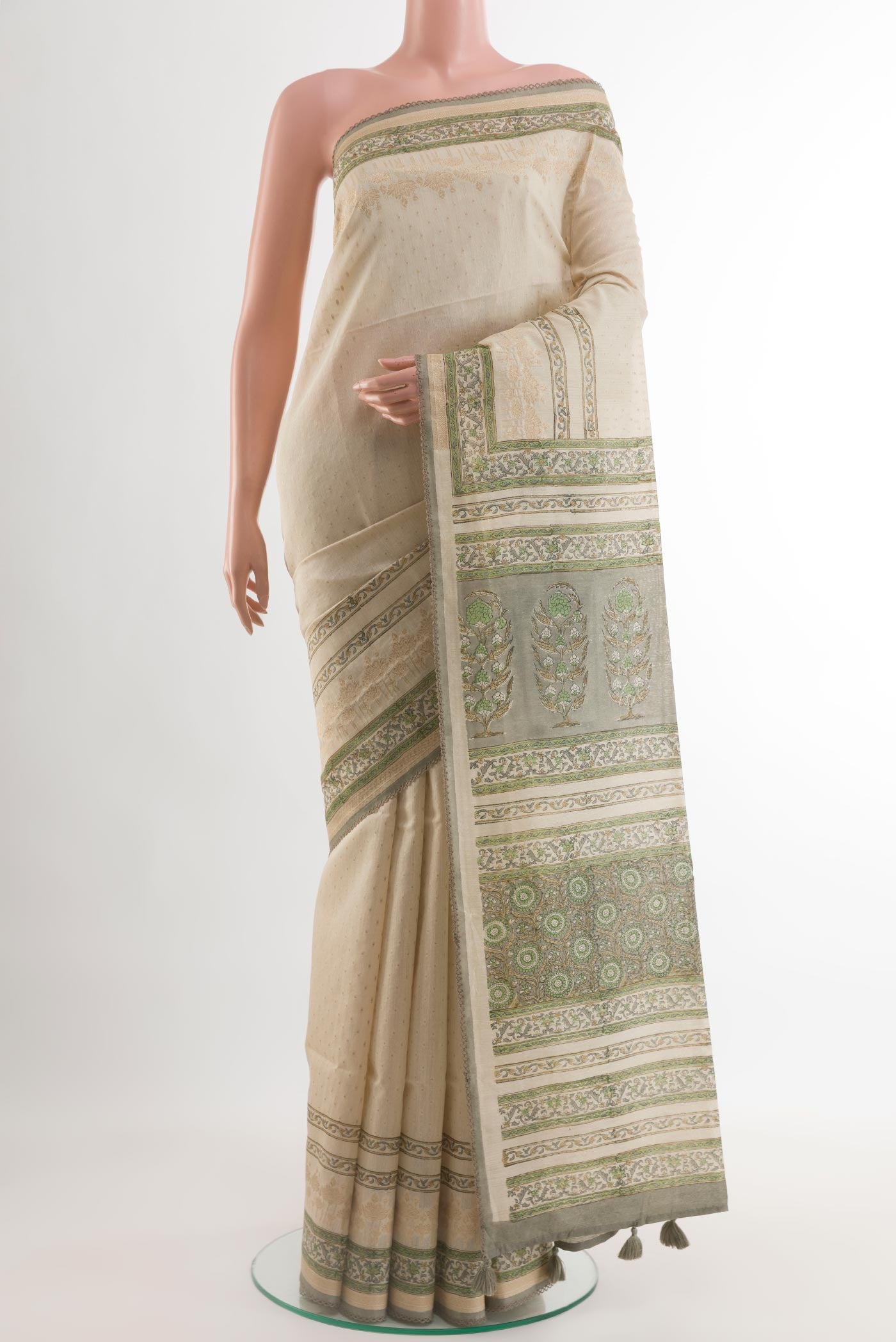 Cream Tussar Silk Saree with Zari Butta on the body and Printed Border.  displayed on a mannequin