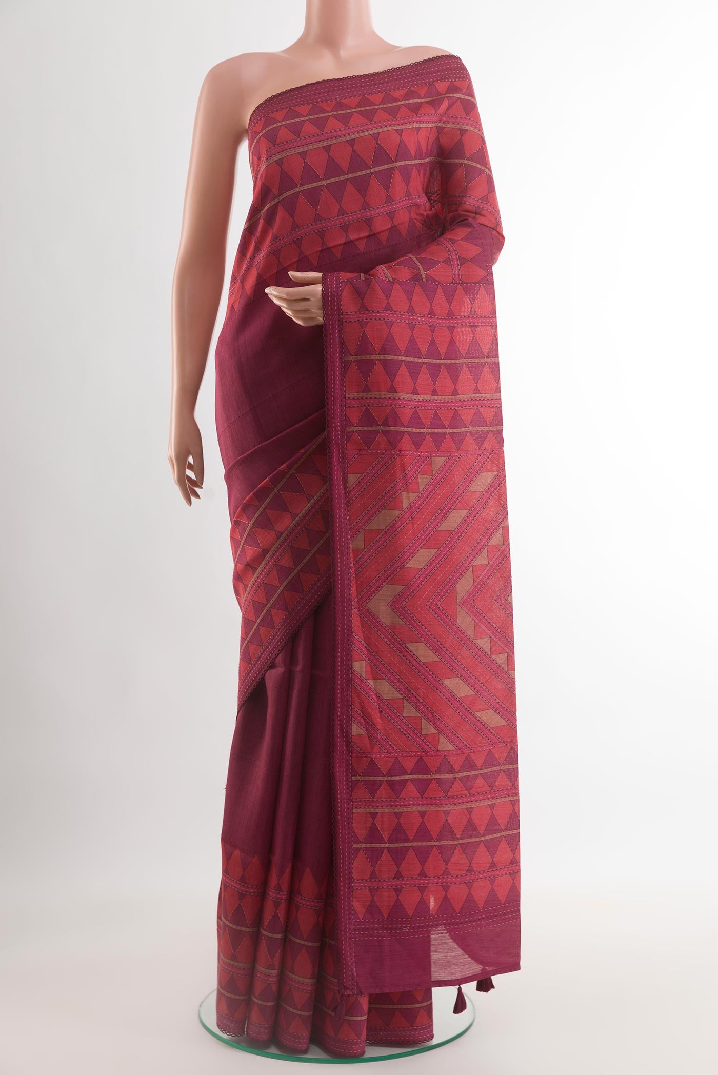 Maroon Tussar Silk Saree with Printed design on the body and Printed Border.  displayed on a mannequin