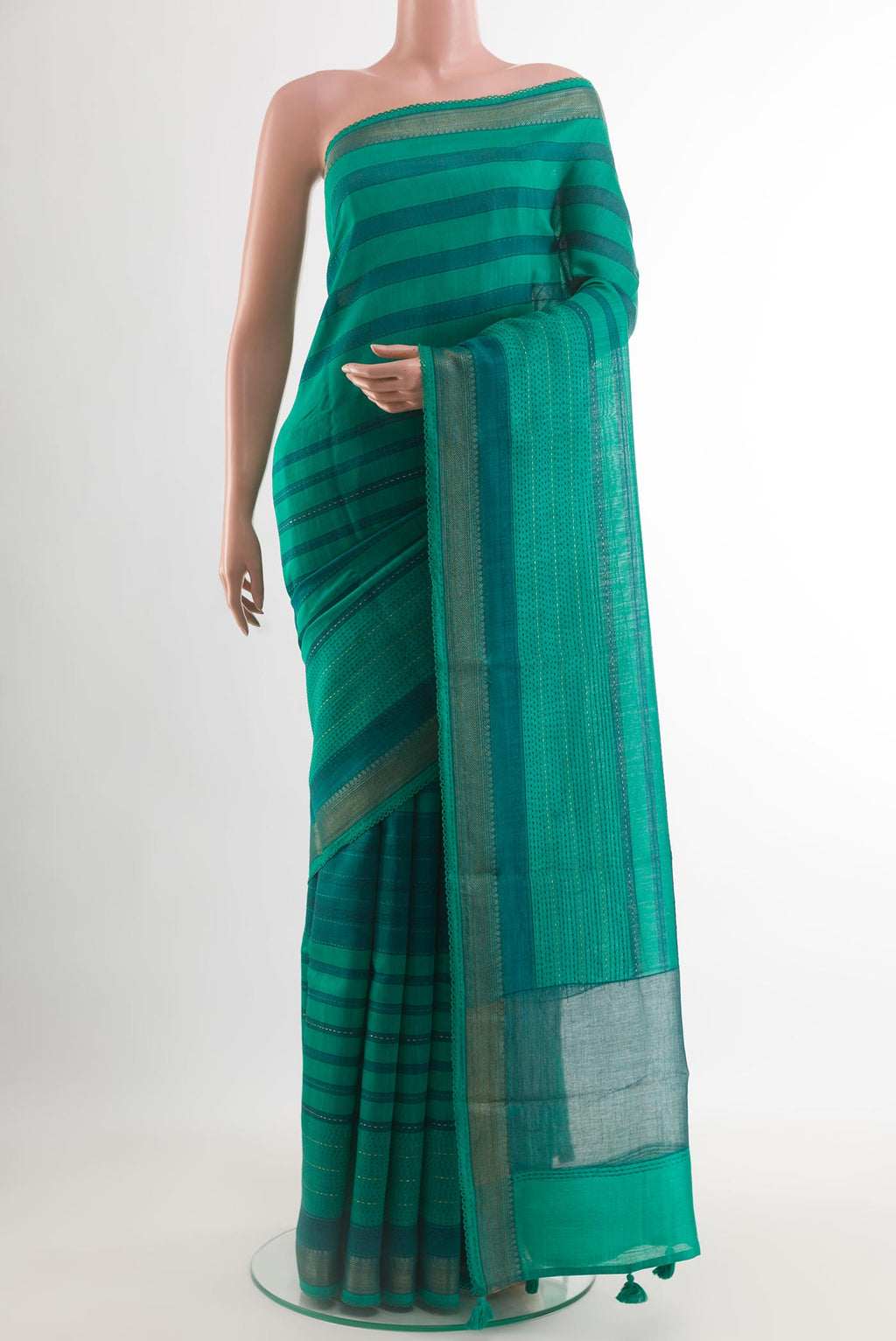 Sea Green Tussar Silk Saree with Printed design on the body and Zari Border.  displayed on a mannequin