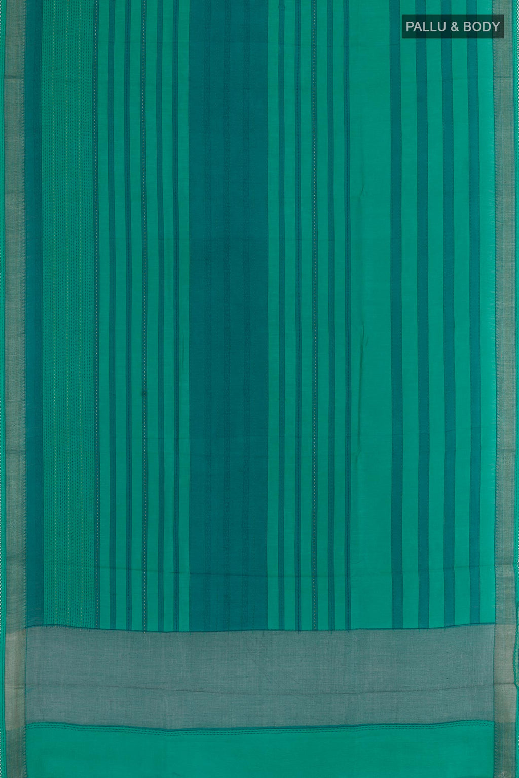 Flat view of Sea Green Tussar Silk Saree with Printed design on the body and Zari Border. 