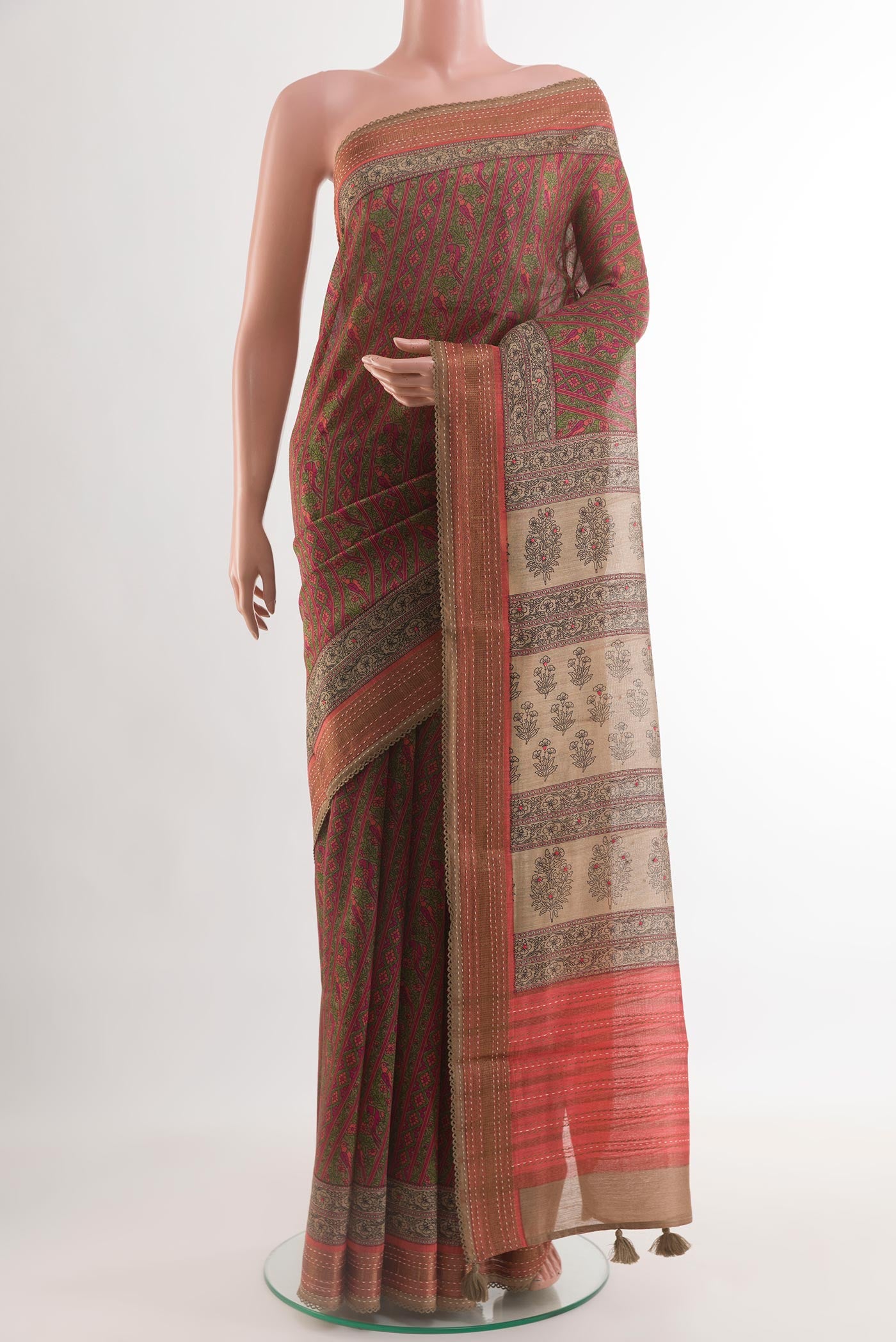 Coral Tussar Silk Saree with Printed design on the body and Zari Border.  displayed on a mannequin
