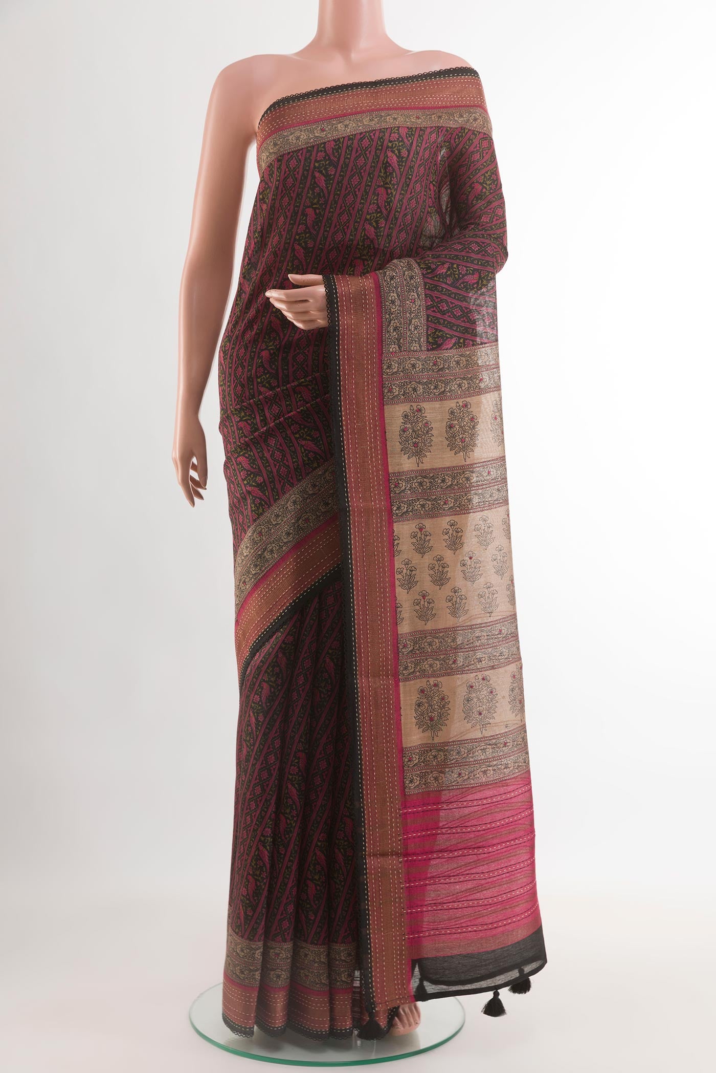 Black Tussar Silk Saree with Printed design on the body and Zari Border.  displayed on a mannequin