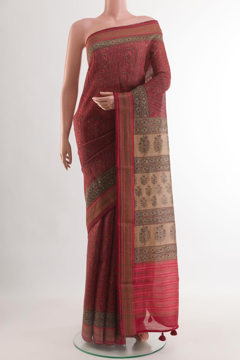 Red Tussar Silk Saree with Printed design on the body and Zari Border.  displayed on a mannequin