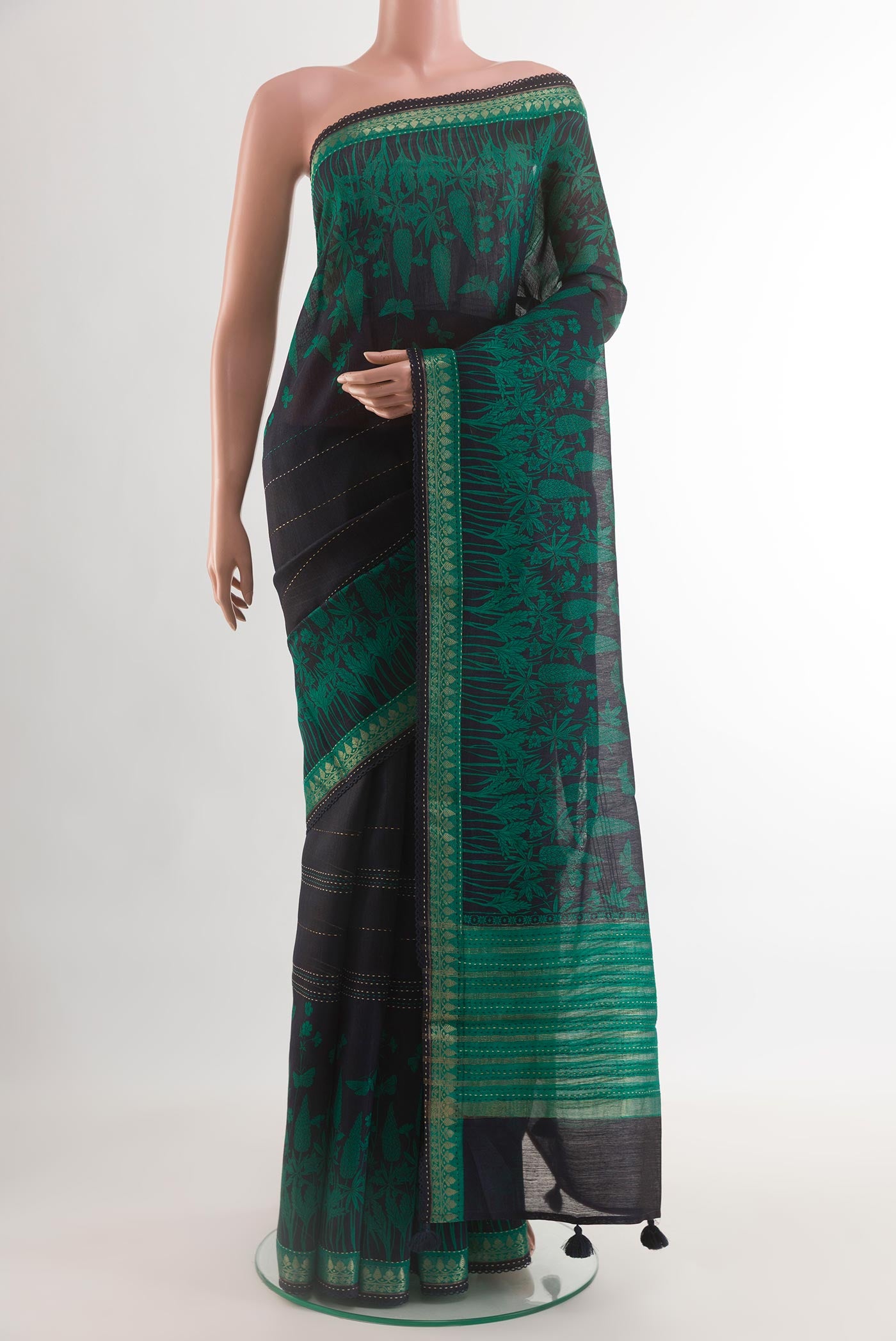 Navy Blue Tussar Silk Saree with Printed design on the body and Zari Border.  displayed on a mannequin