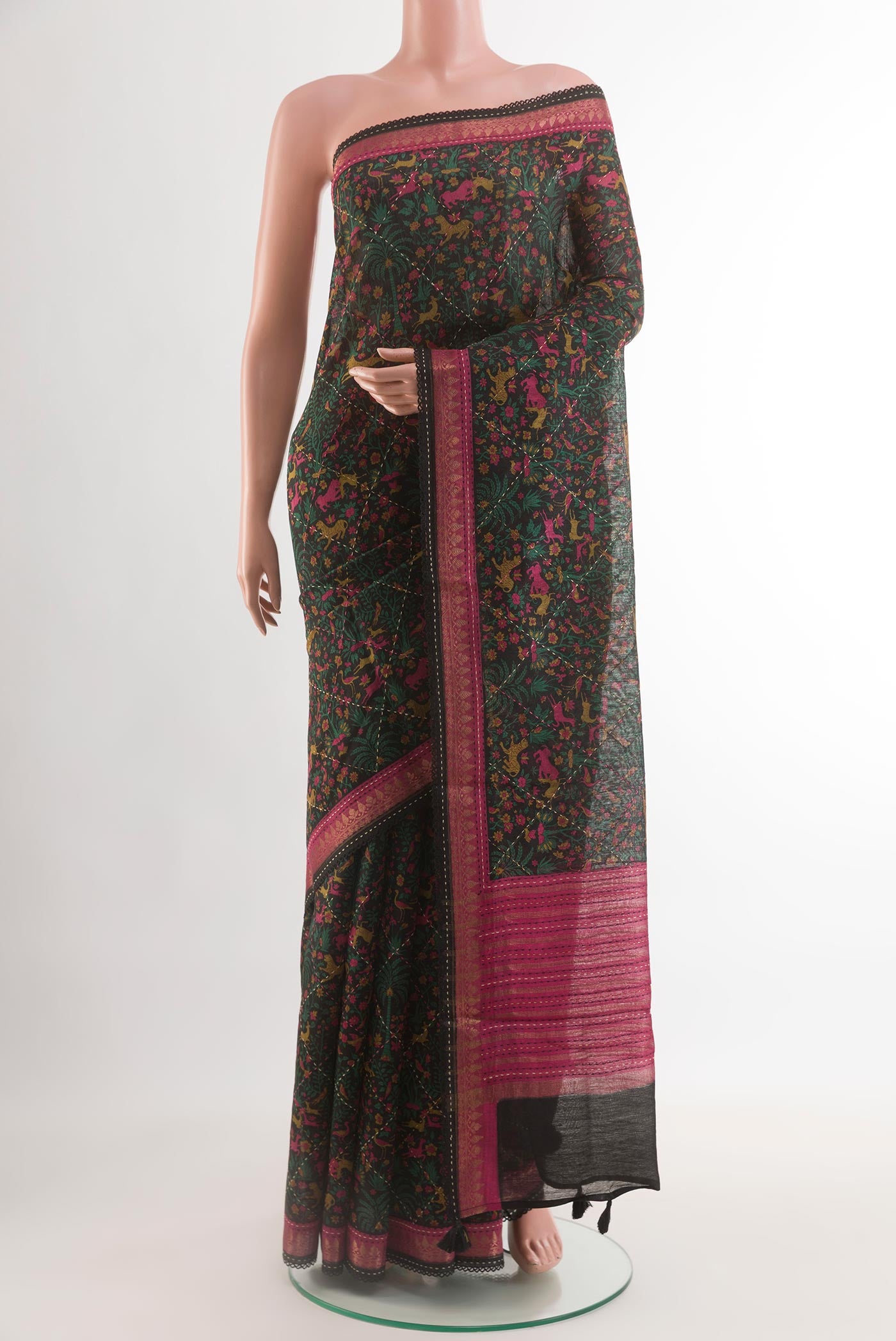 Black Tussar Silk Saree with Printed design on the body and Zari Border.  displayed on a mannequin