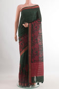 Bottle Green Tussar Saree with Stripes on the body and Zari Border.  displayed on a mannequin