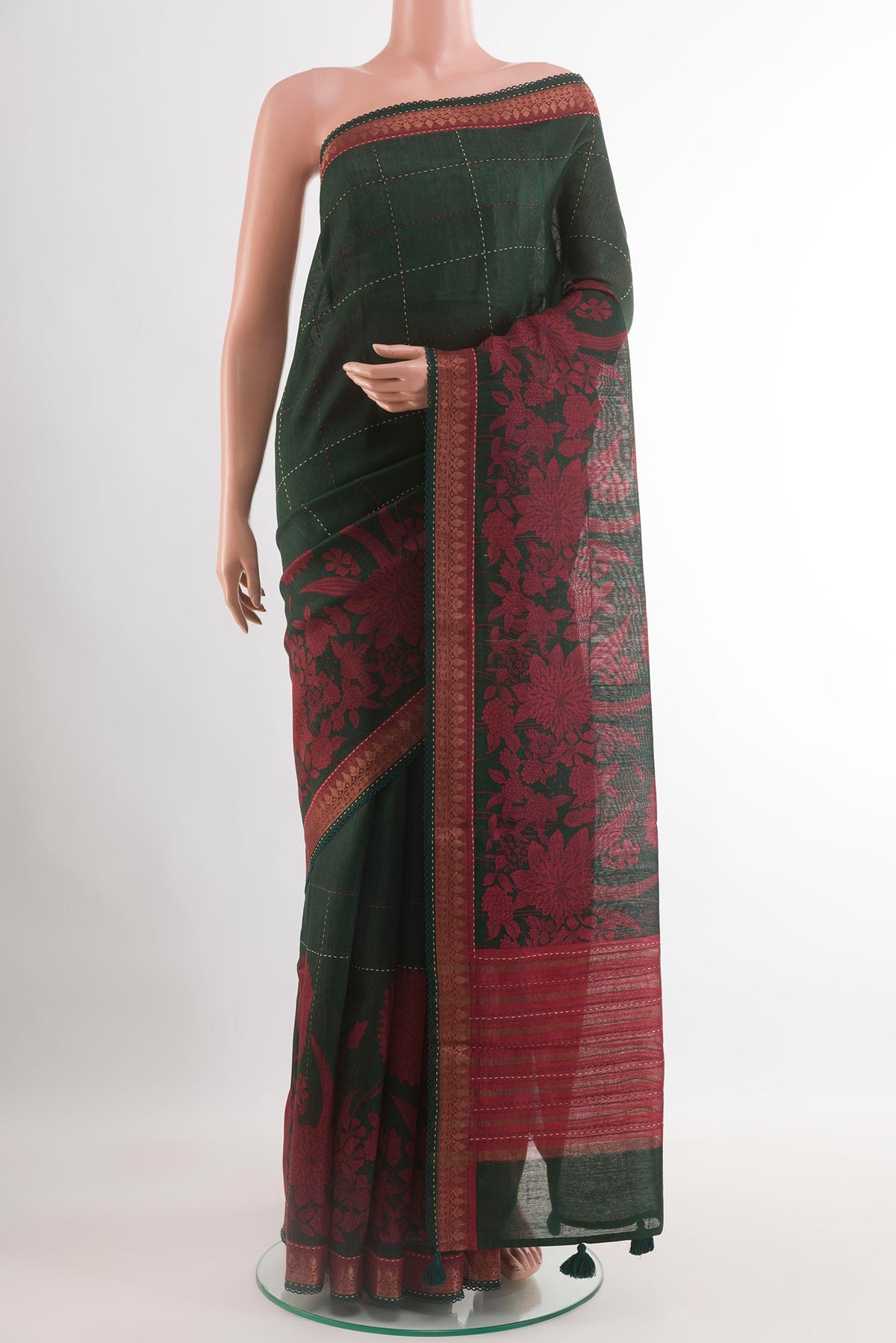 Bottle Green Tussar Saree with Stripes on the body and Zari Border.  displayed on a mannequin