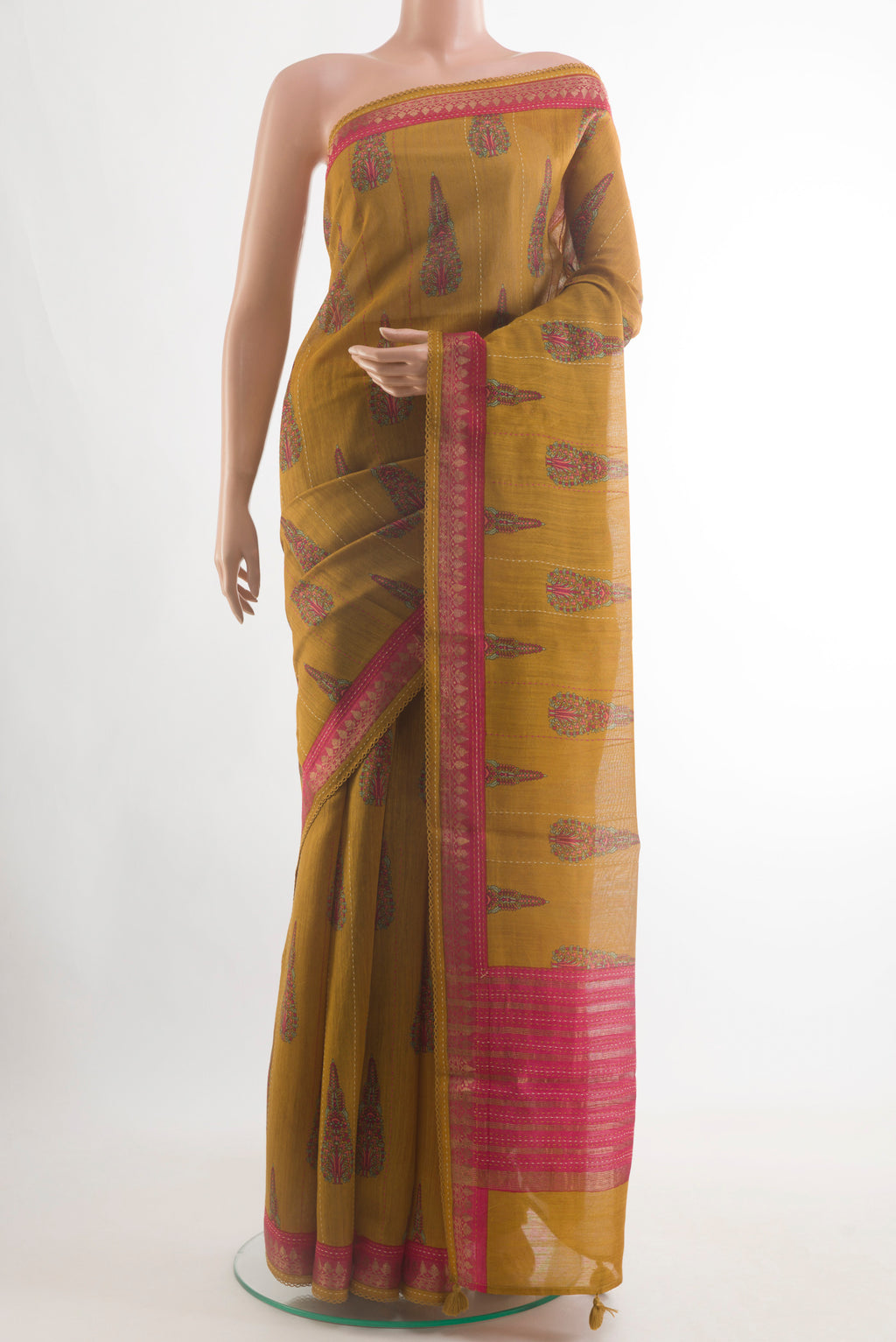 Mustard Tussar Silk Saree with Printed design on the body and Zari Border.  displayed on a mannequin