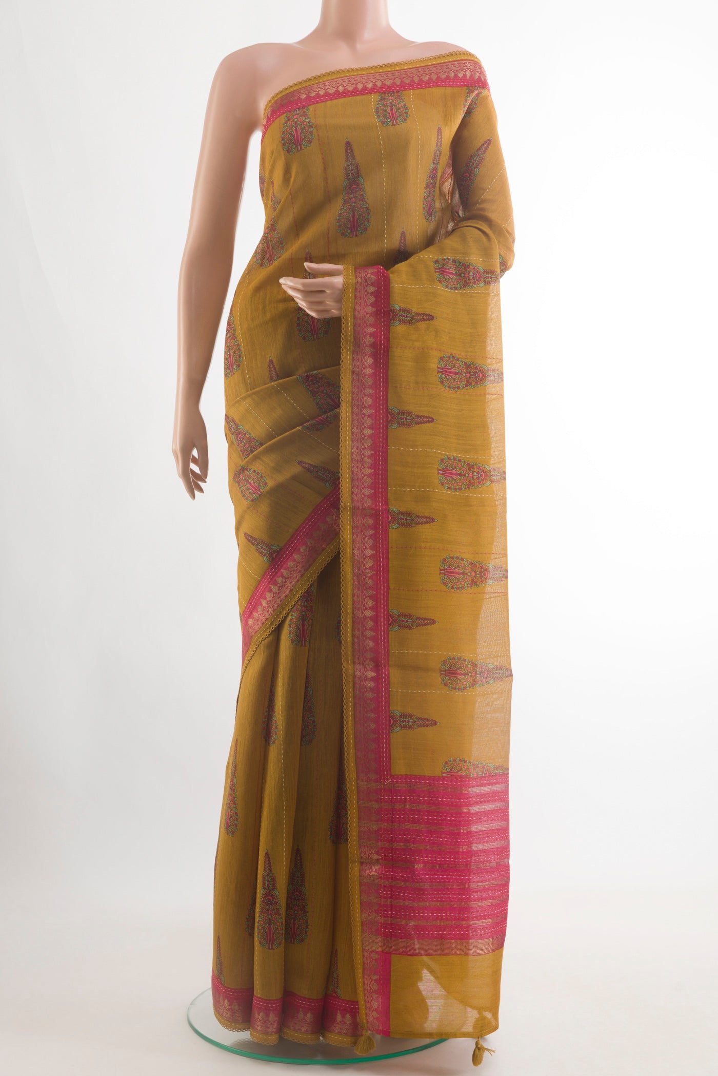Mustard Tussar Silk Saree with Printed design on the body and Zari Border.  displayed on a mannequin