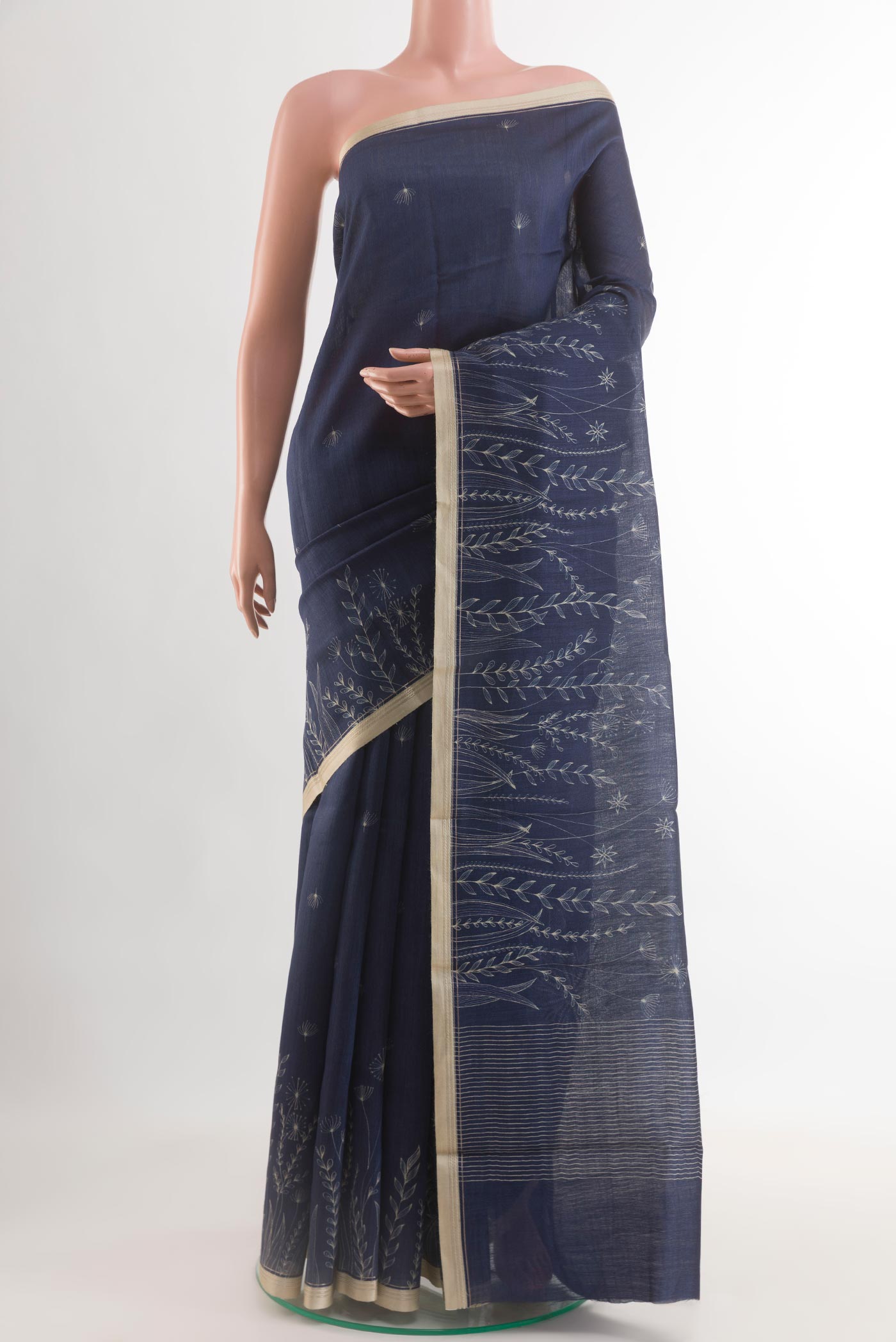 Navy Blue Tussar Silk Saree with Printed design on the body and Zari Border.  displayed on a mannequin