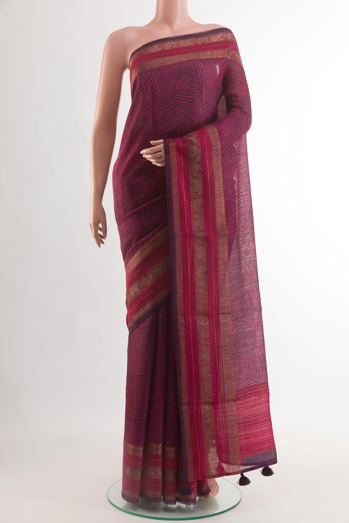 Purple Tussar Silk Saree with Printed design on the body and Zari Border.  displayed on a mannequin