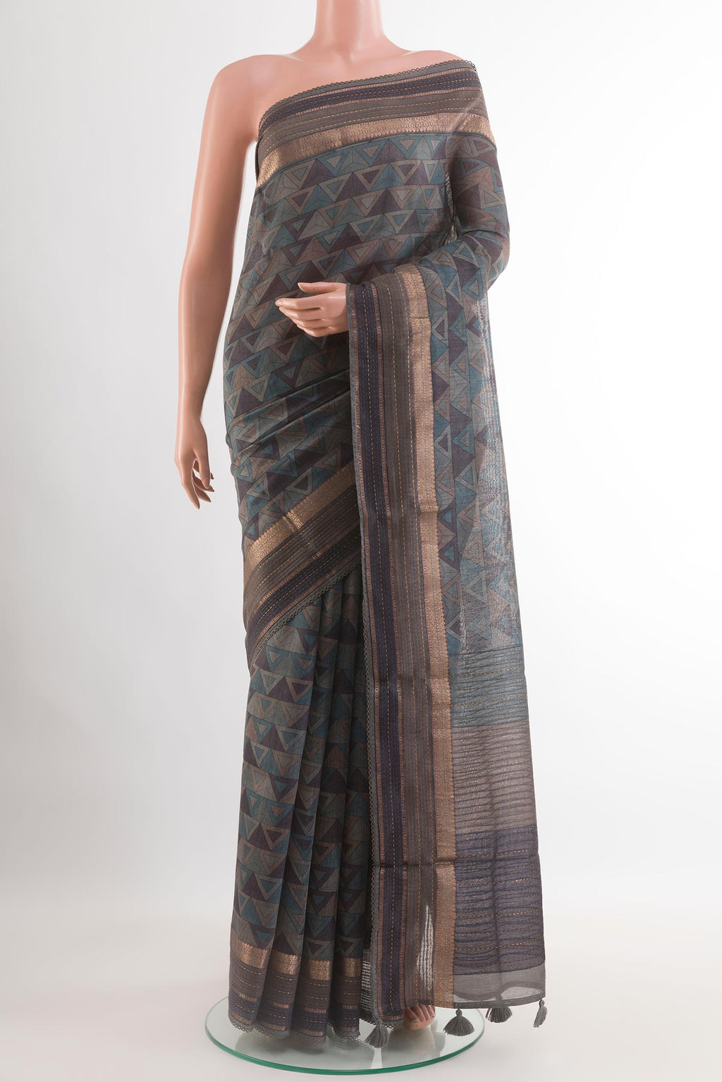 Grey Tussar Saree with Printed design on the body and Zari Border.  displayed on a mannequin