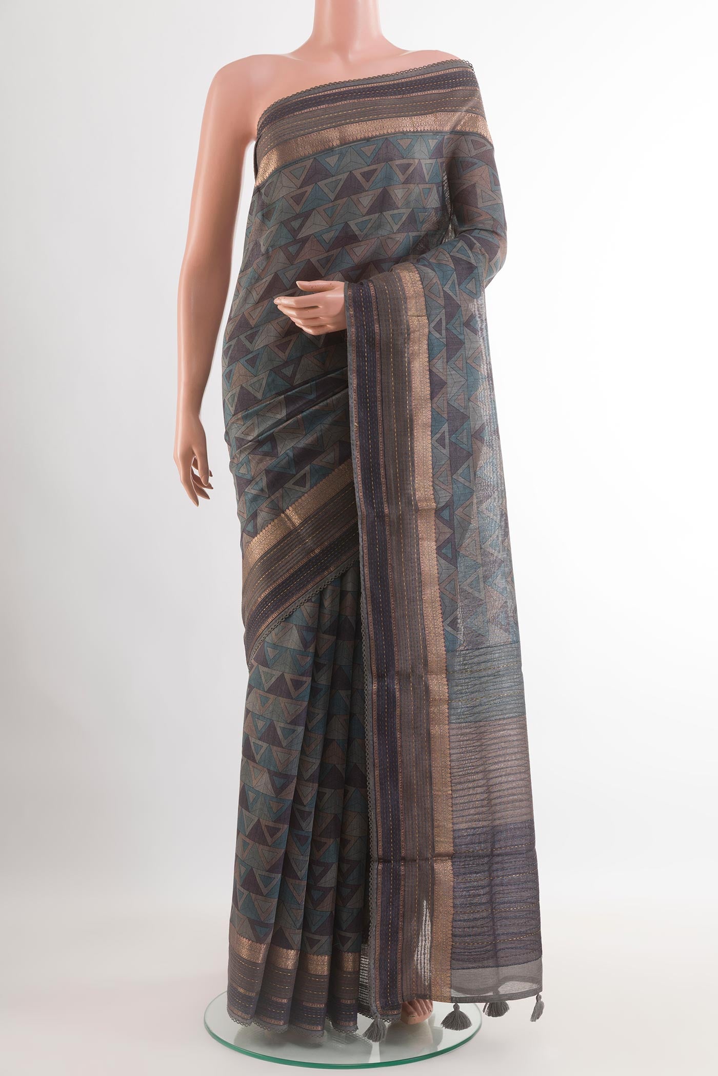 Grey Tussar Saree with Printed design on the body and Zari Border.  displayed on a mannequin