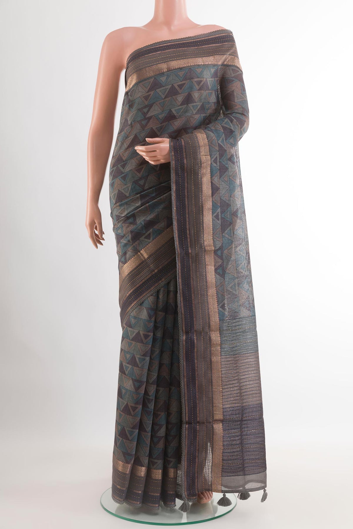 Grey Tussar Saree with Printed design on the body and Zari Border.  displayed on a mannequin