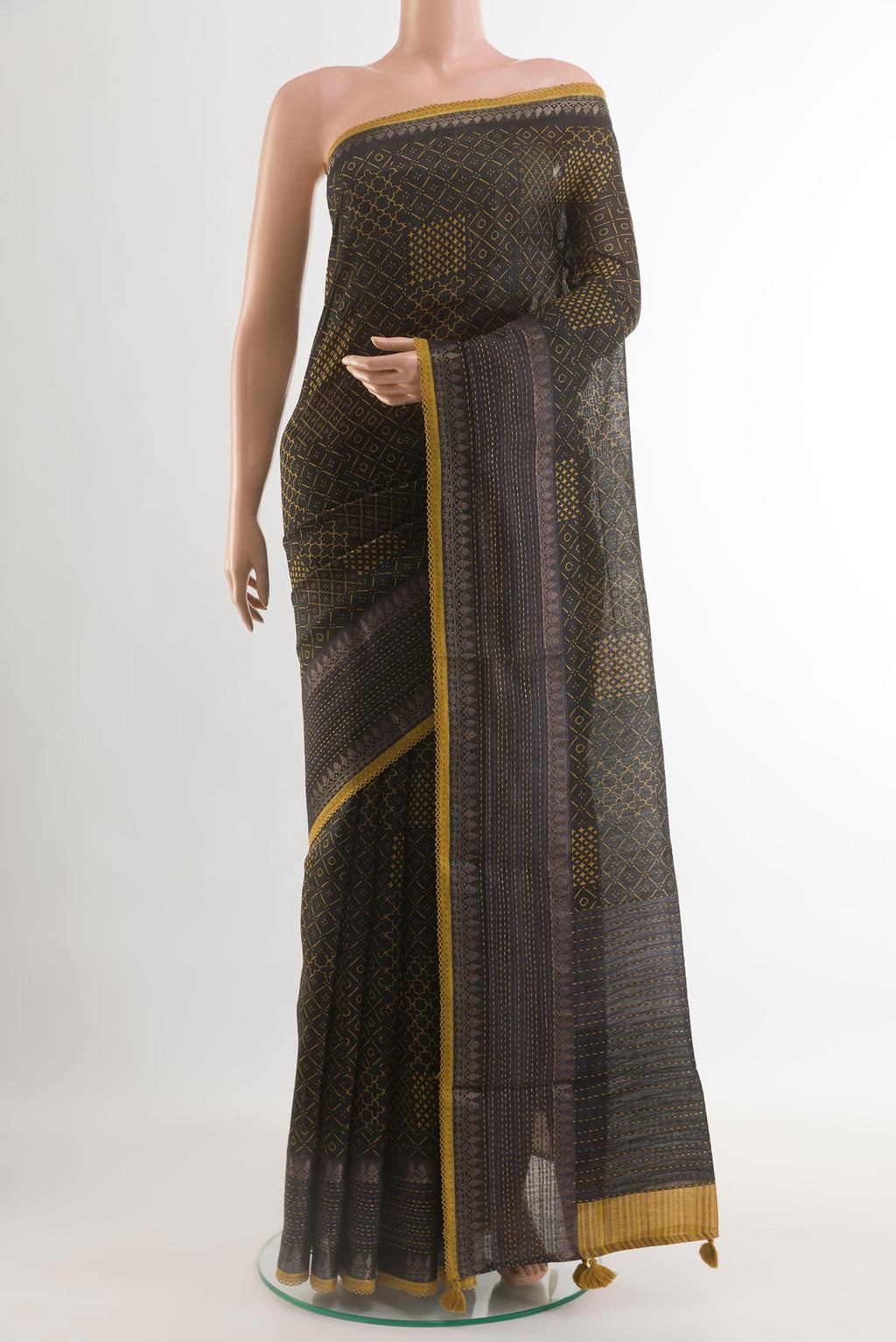 Black Tussar Saree with Printed design on the body and Zari Border.  displayed on a mannequin