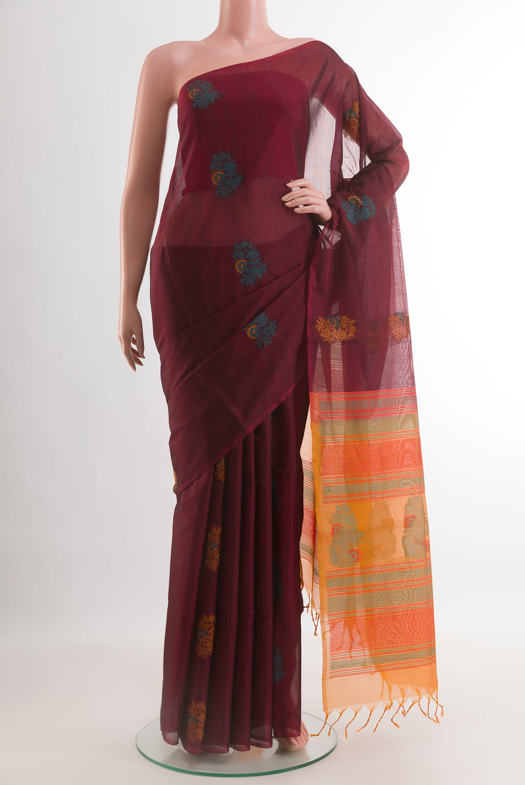 Maroon Silk Cotton Saree with Thread Butta on the body and Without Border.  displayed on a mannequin