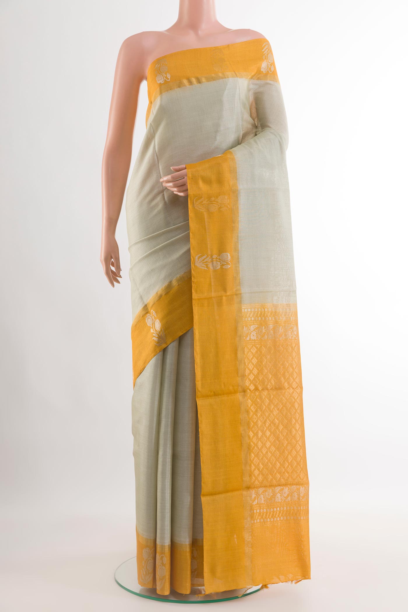 Off White Tussar Saree with Plain Body and Zari Border.  displayed on a mannequin