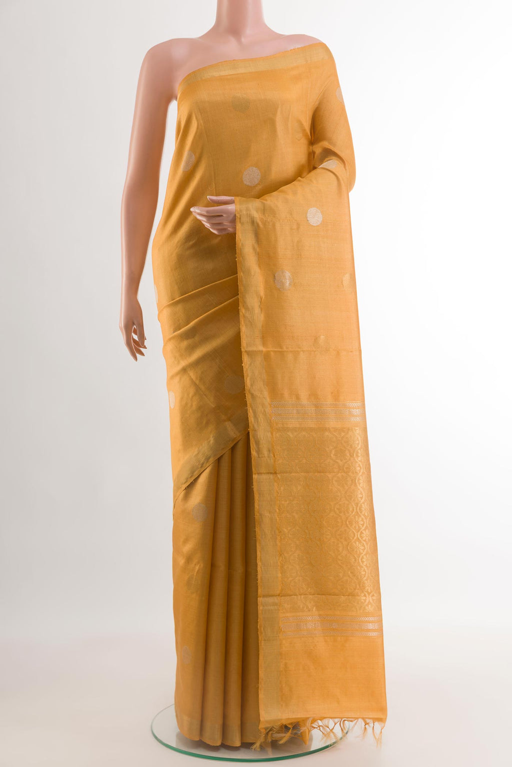 Yellow Tussar Saree with Zari Butta on the body and Zari Border.  displayed on a mannequin