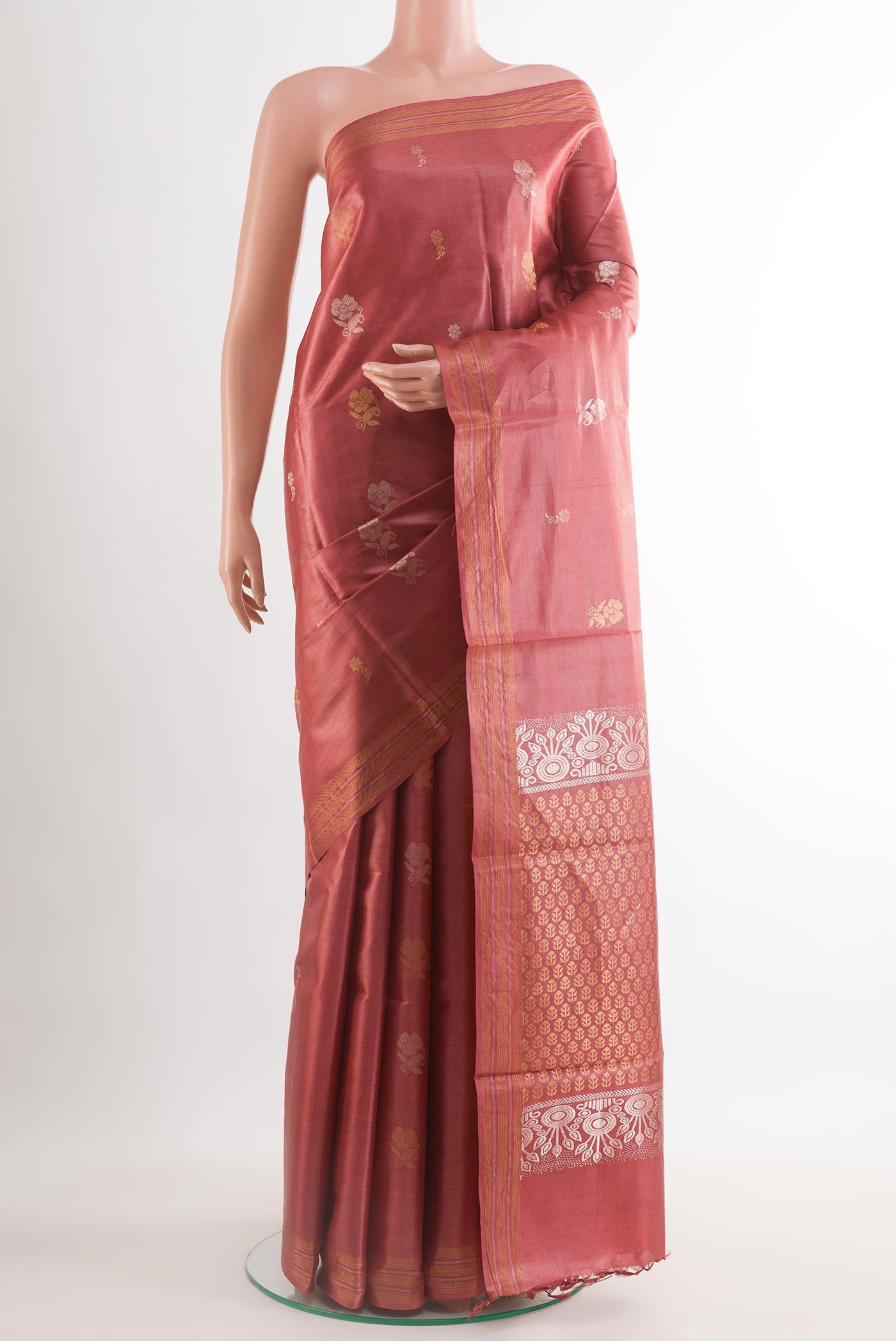 Rust Tussar Silk Saree with Zari Butta on the body and Zari Border.  displayed on a mannequin