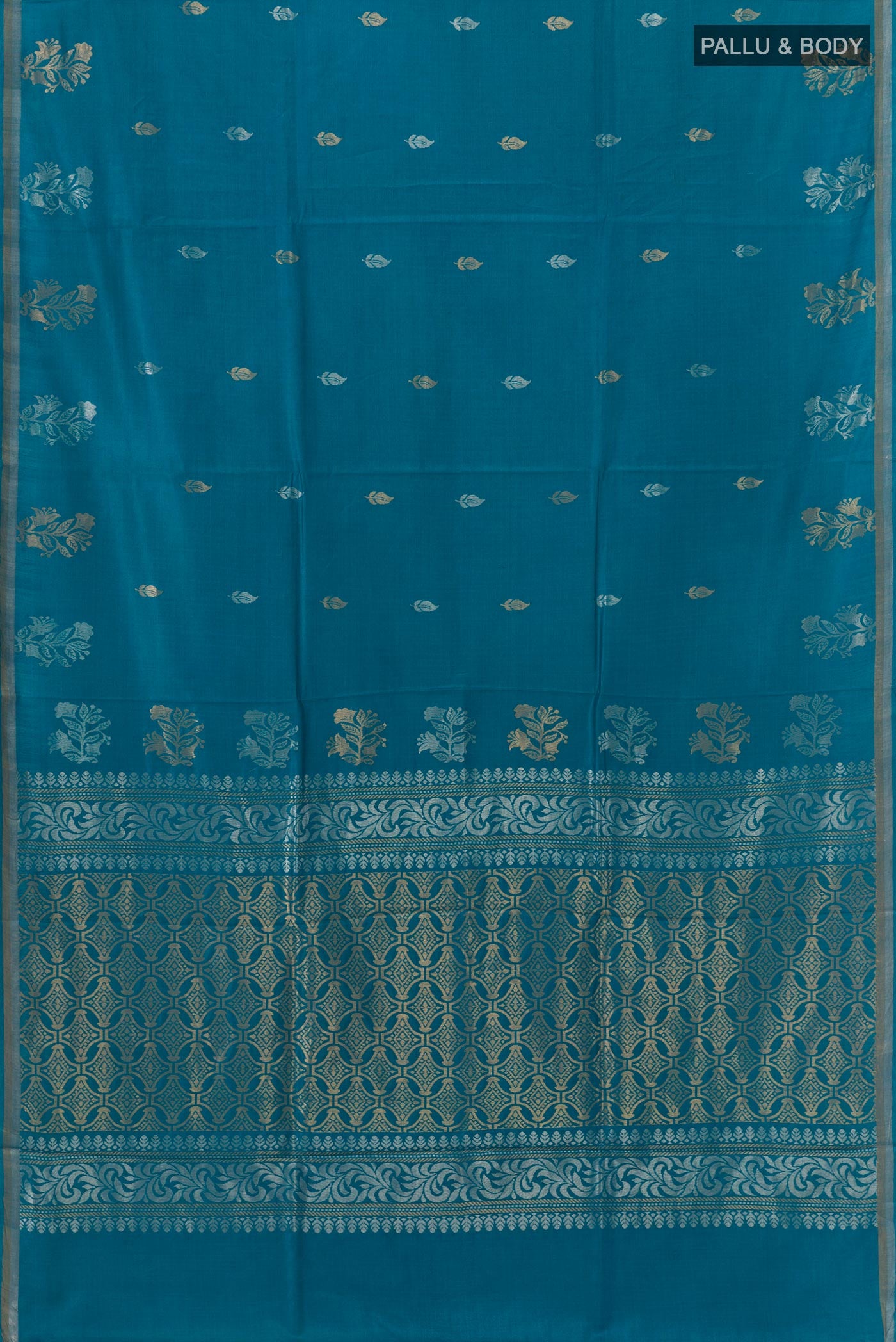 Flat view of Blue Tussar Saree with Zari Butta on the body and Zari Border. 