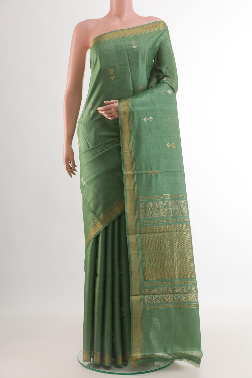Sage Green Tussar Silk Saree with Zari Butta on the body and Zari Border.  displayed on a mannequin