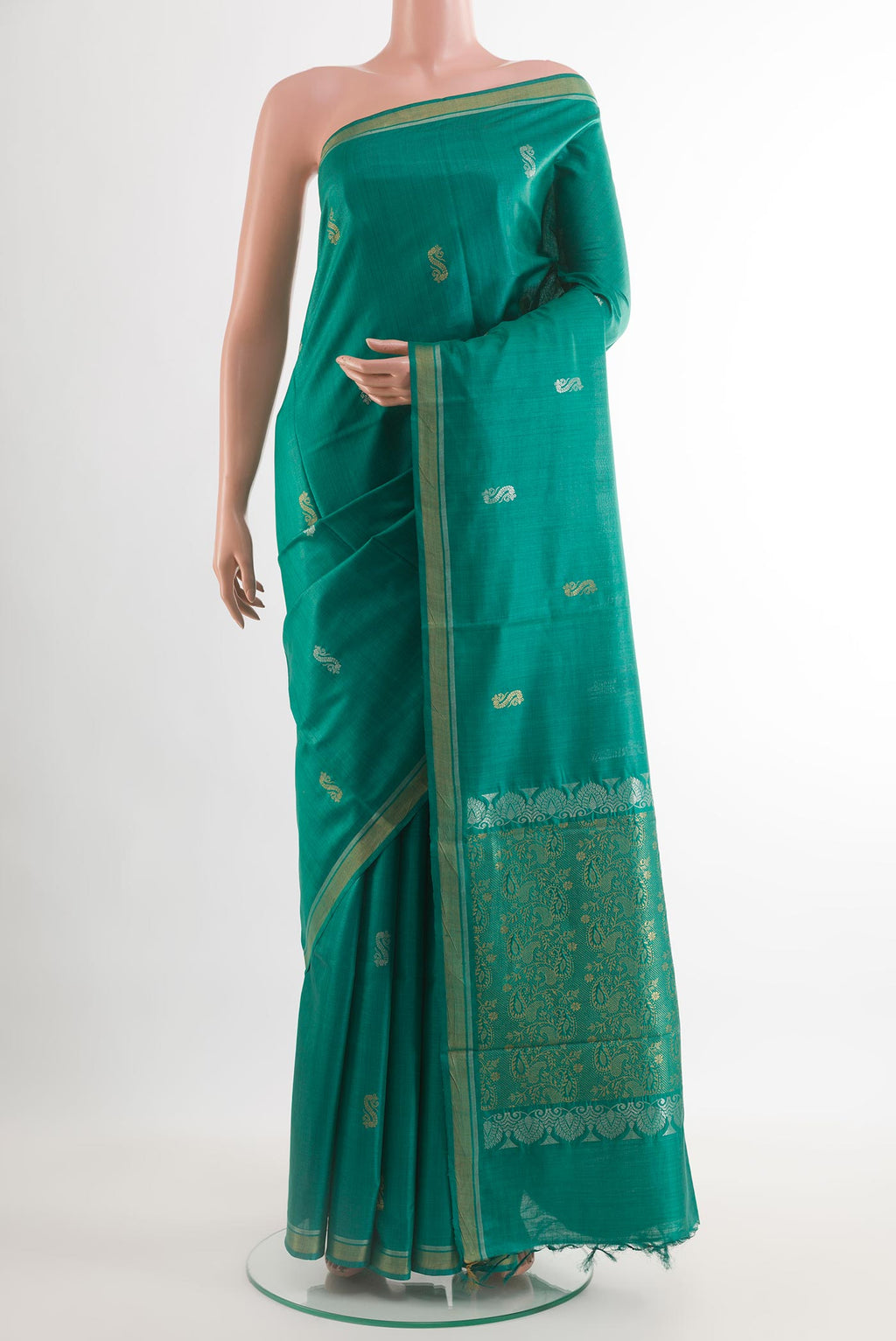 Teal Tussar Saree with Zari Butta on the body and Zari Border.  displayed on a mannequin