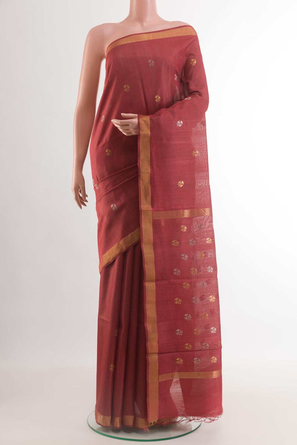 Maroon Tussar Silk Saree with Zari Butta on the body and Zari Border.  displayed on a mannequin