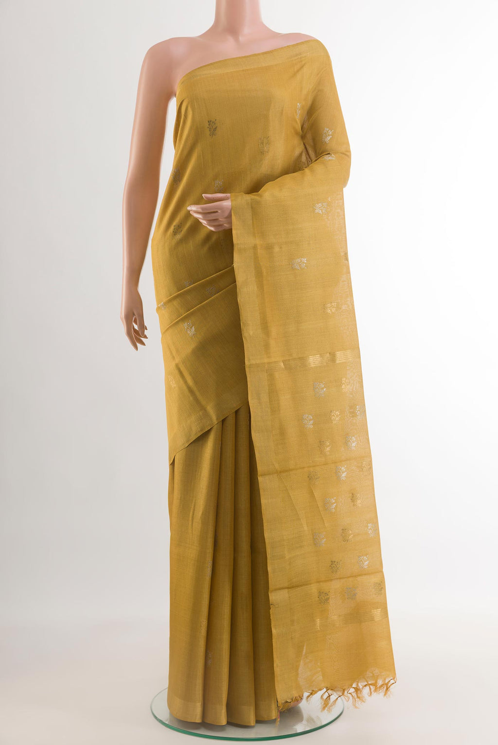 Mustard Tussar Silk Saree with Zari Butta on the body and Zari Border.  displayed on a mannequin