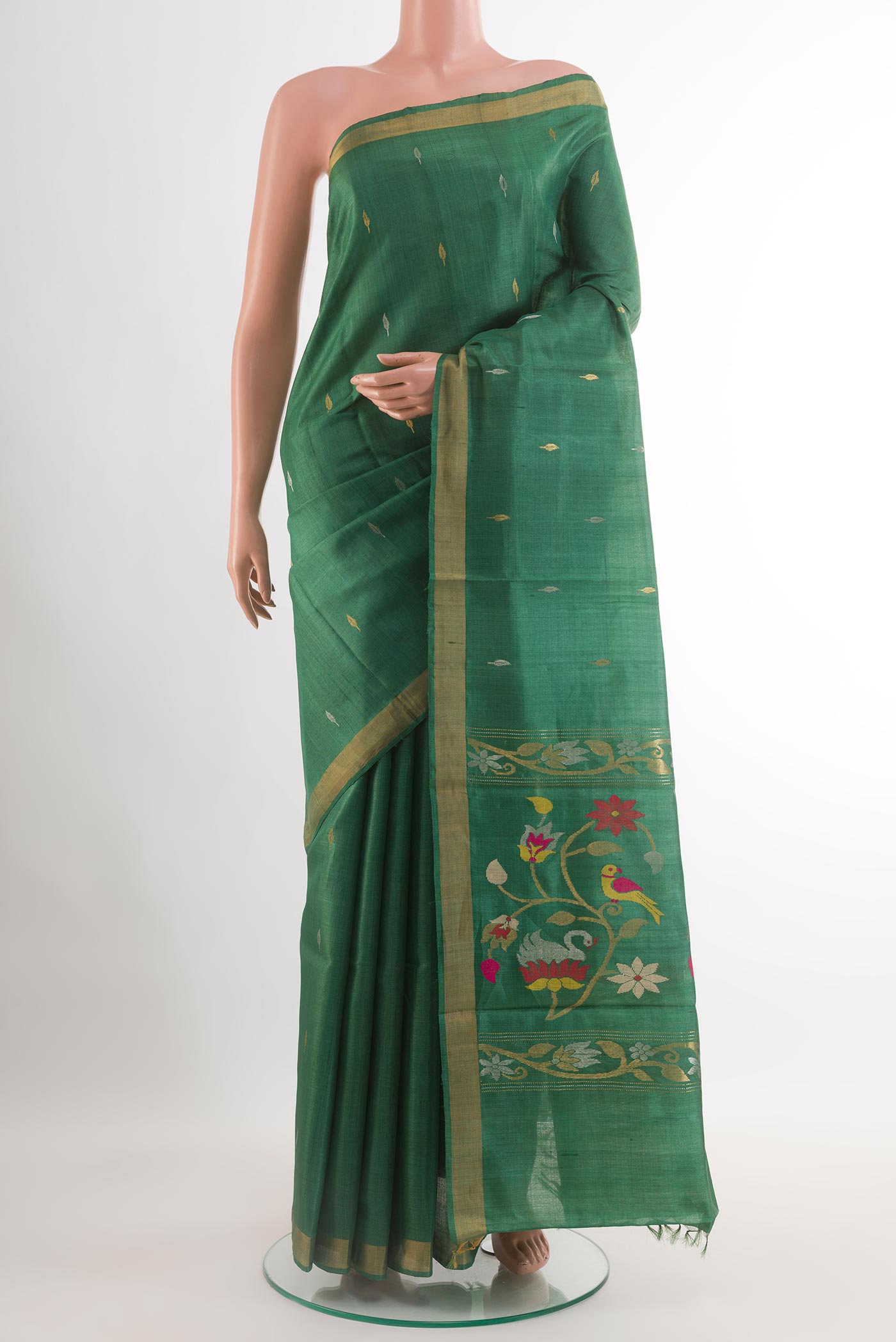 Green Tussar Saree with Printed design on the body and Zari Border.  displayed on a mannequin