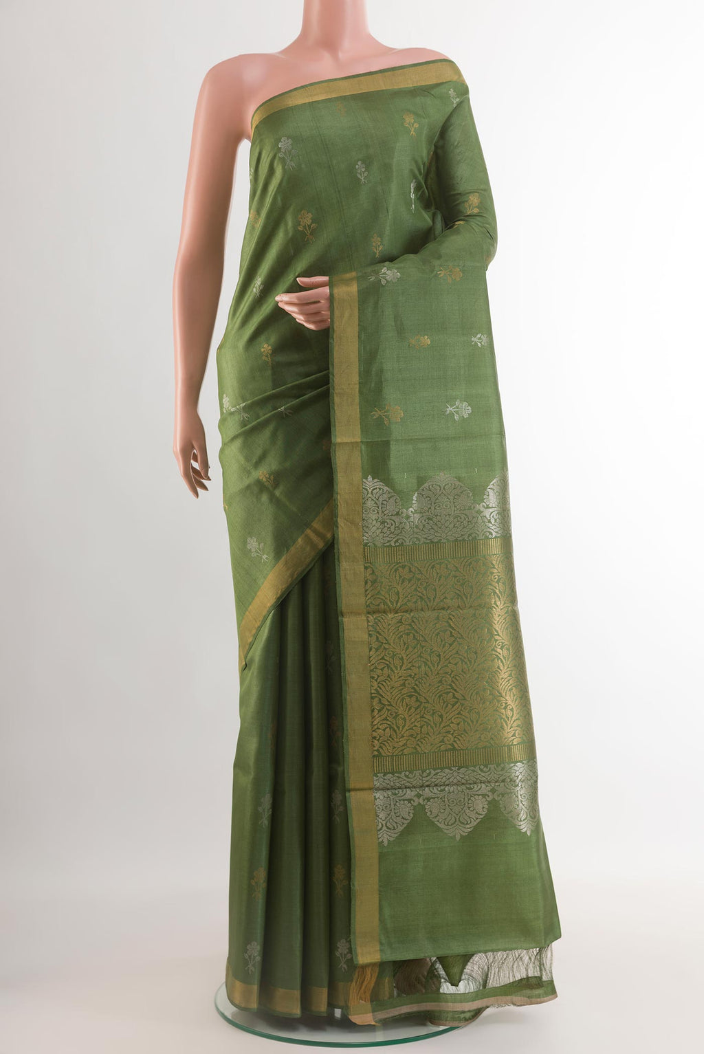 Green Tussar Silk Saree with Zari Butta on the body and Zari Border.  displayed on a mannequin