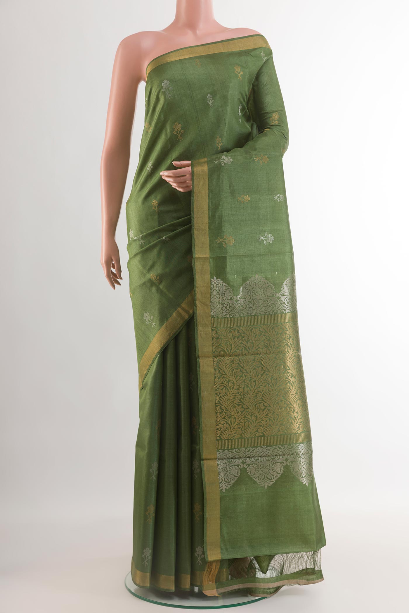 Green Tussar Silk Saree with Zari Butta on the body and Zari Border.  displayed on a mannequin