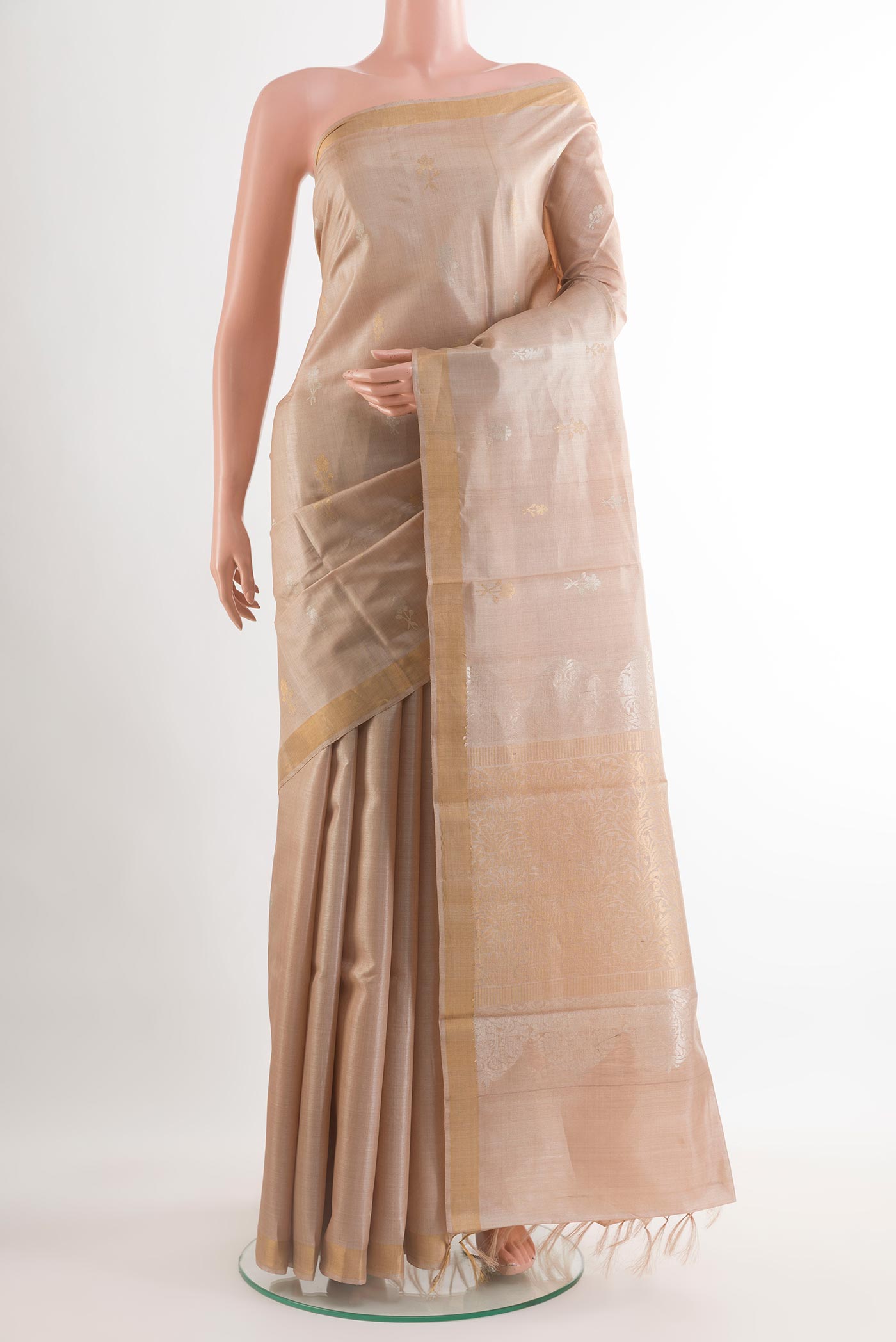 Beige Tussar Silk Saree with Zari Butta on the body and Zari Border.  displayed on a mannequin