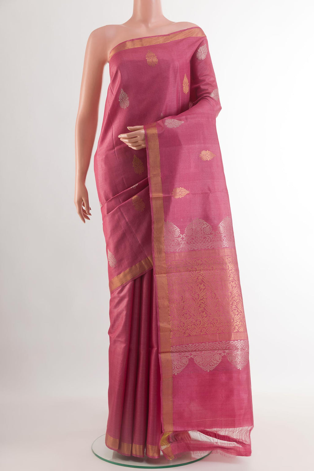 Pink Tussar Silk Saree with Zari Butta on the body and Zari Border.  displayed on a mannequin