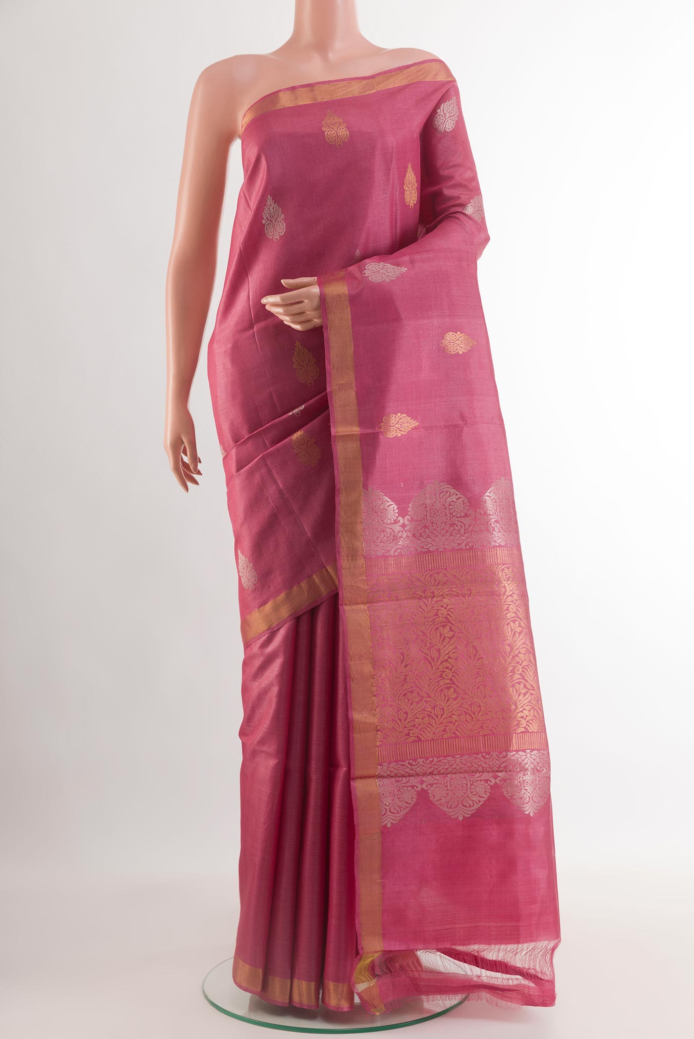 Pink Tussar Silk Saree with Zari Butta on the body and Zari Border.  displayed on a mannequin
