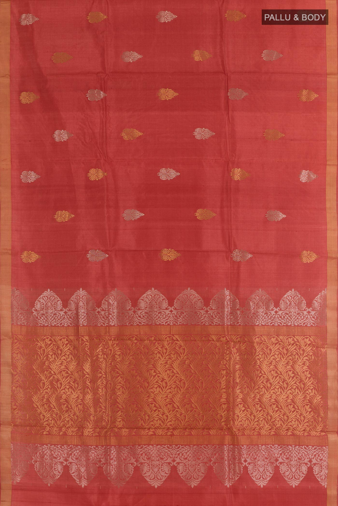 Flat view of Rust Tussar Silk Saree with Zari Butta on the body and Zari Border. 