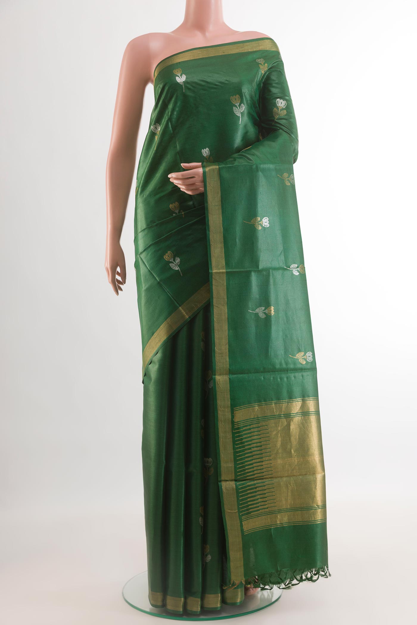 Green Tussar Silk Saree with Zari Butta on the body and Zari Border.  displayed on a mannequin