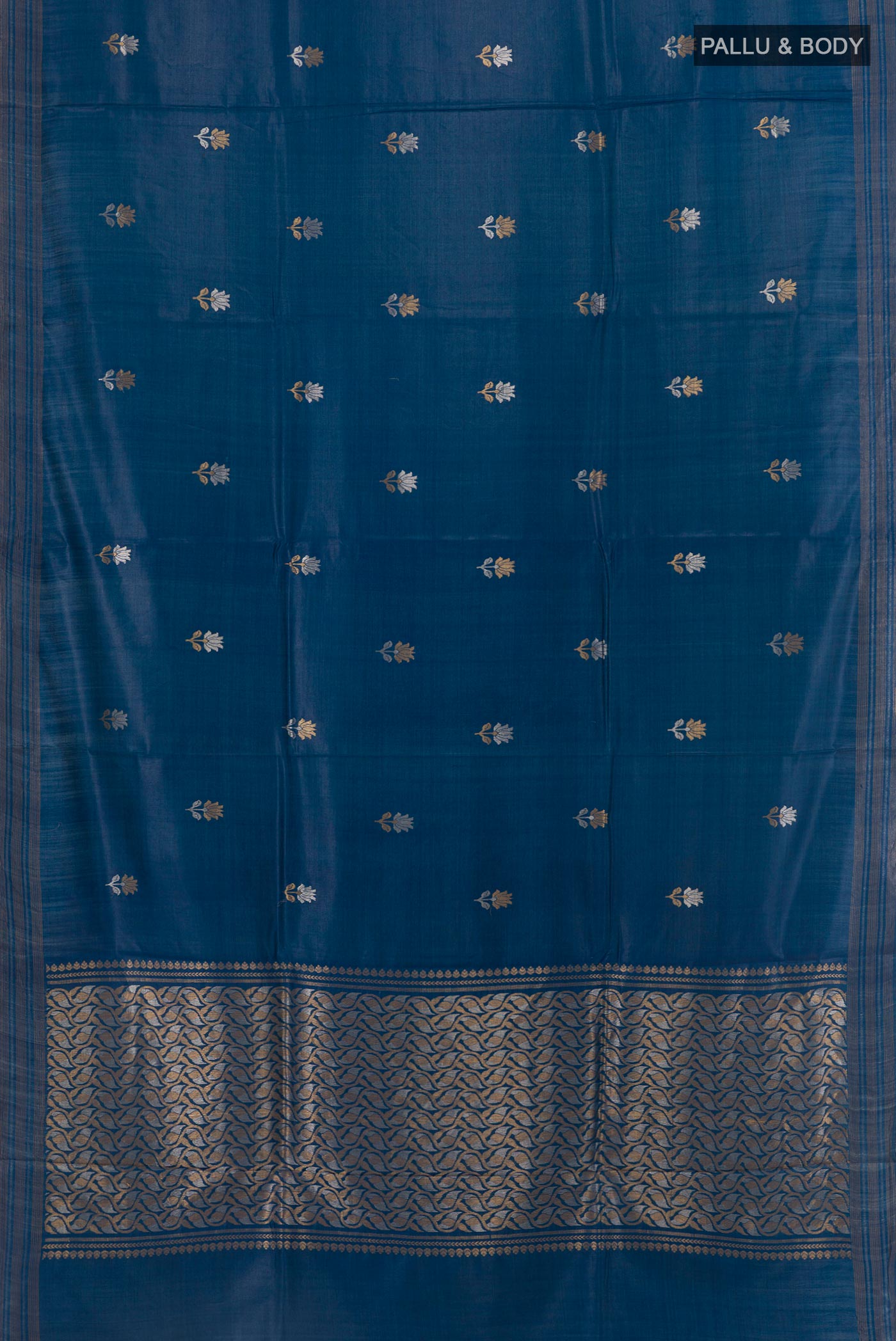 Flat view of Blue Tussar Silk Saree with Zari Butta on the body and Zari Border. 