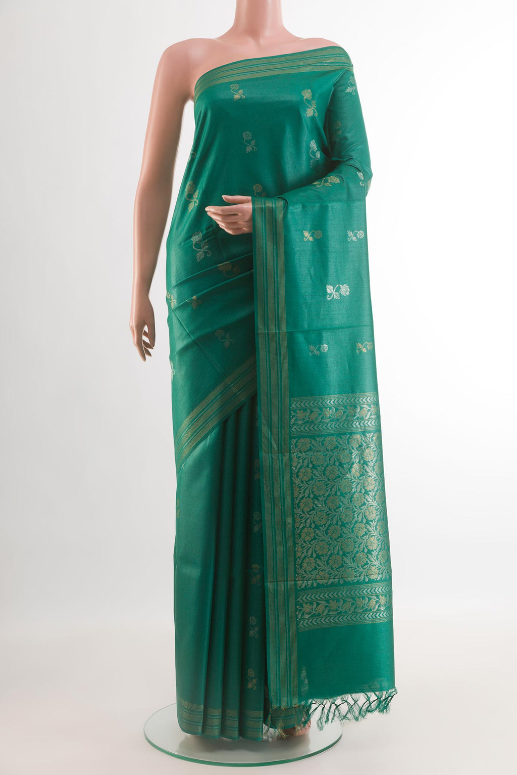 Green Tussar Silk Saree with Zari Butta on the body and Zari Border.  displayed on a mannequin