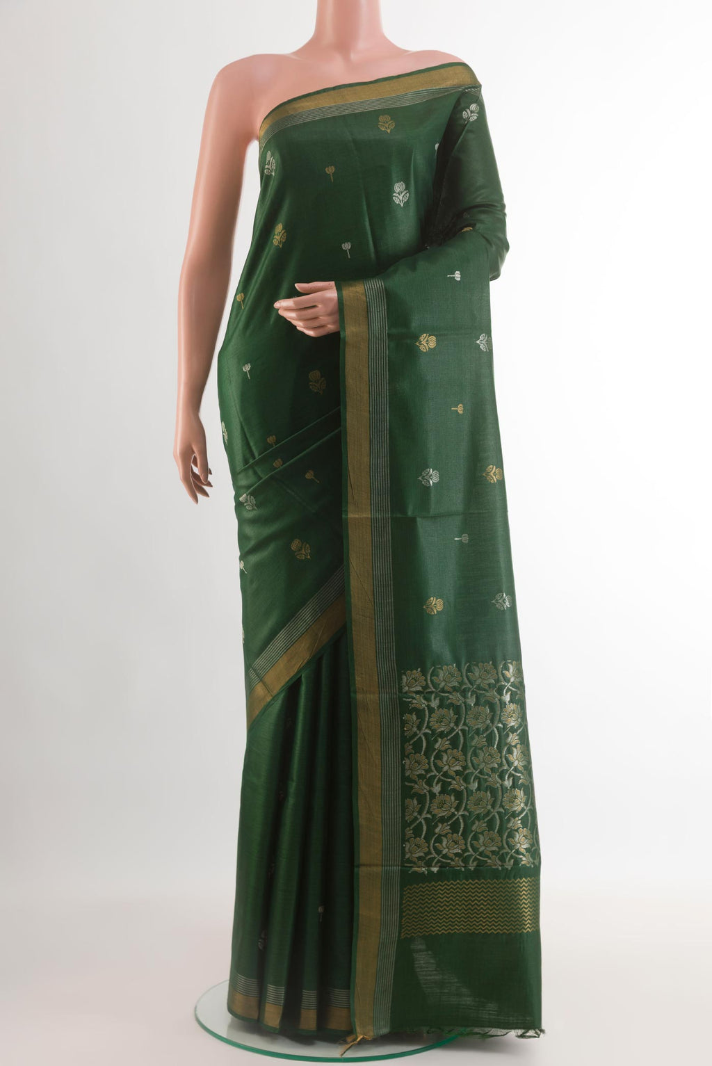 Bottle Green Tussar Silk Saree with Zari Butta on the body and Zari Border.  displayed on a mannequin