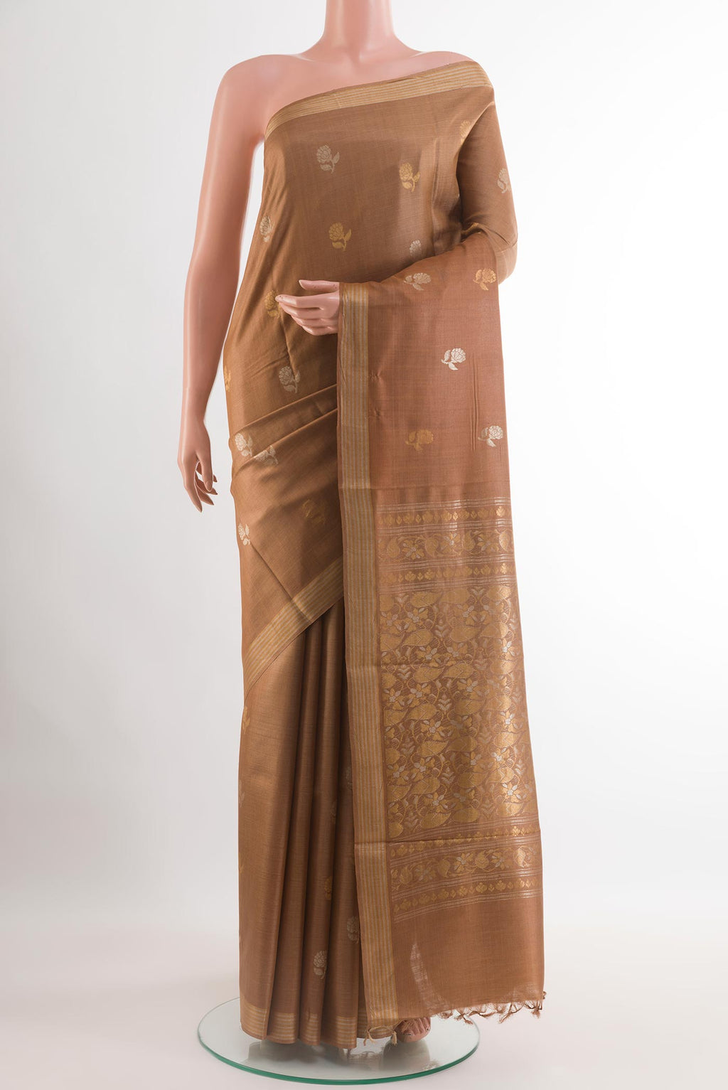 Brown Tussar Saree with Zari Butta on the body and Zari Border.  displayed on a mannequin