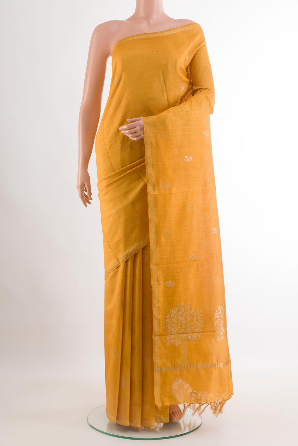 Yellow Tussar Saree with Printed design on the body and Zari Border.  displayed on a mannequin