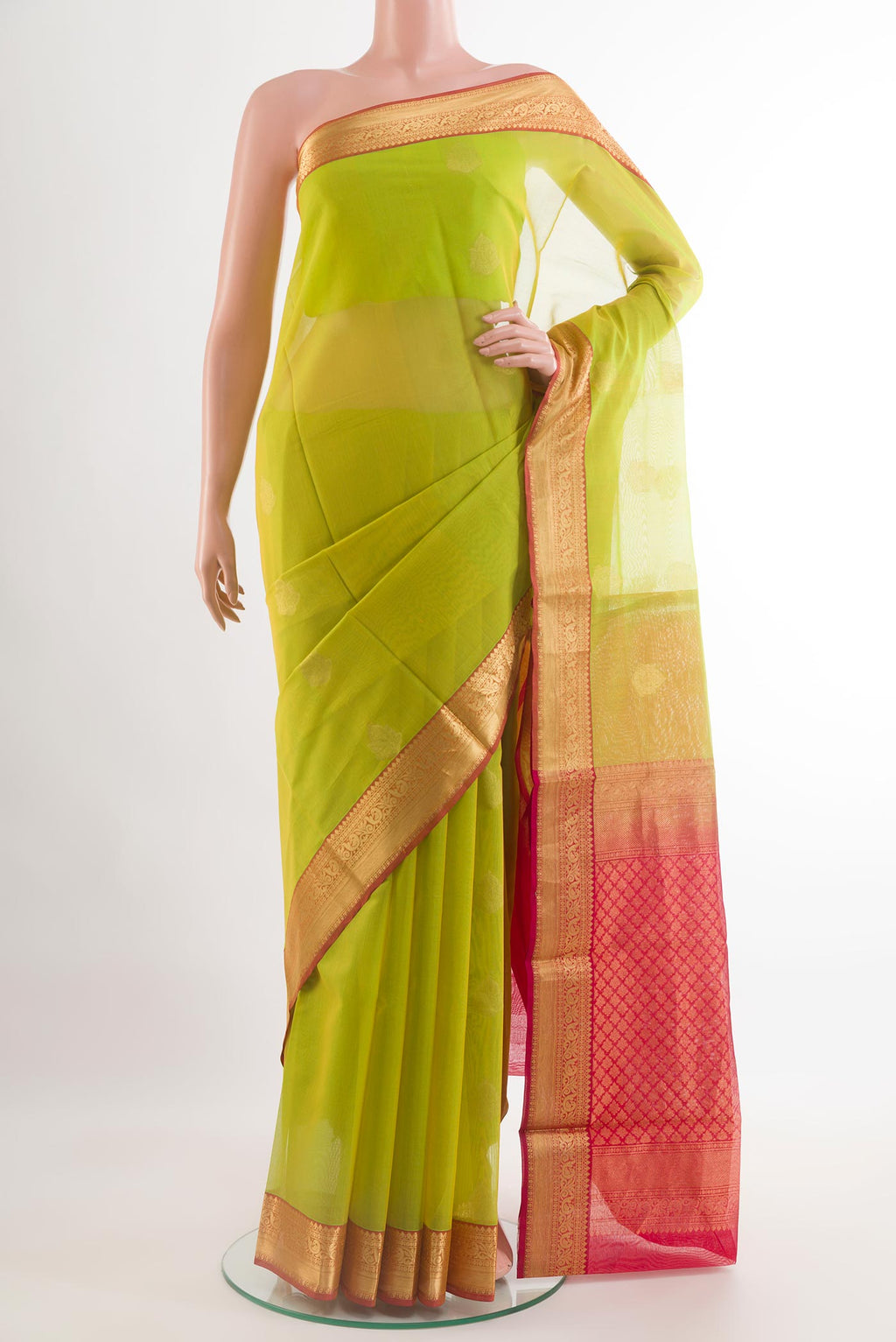 Light Green Silk Cotton Saree with Zari Butta on the body and Zari Border.  displayed on a mannequin