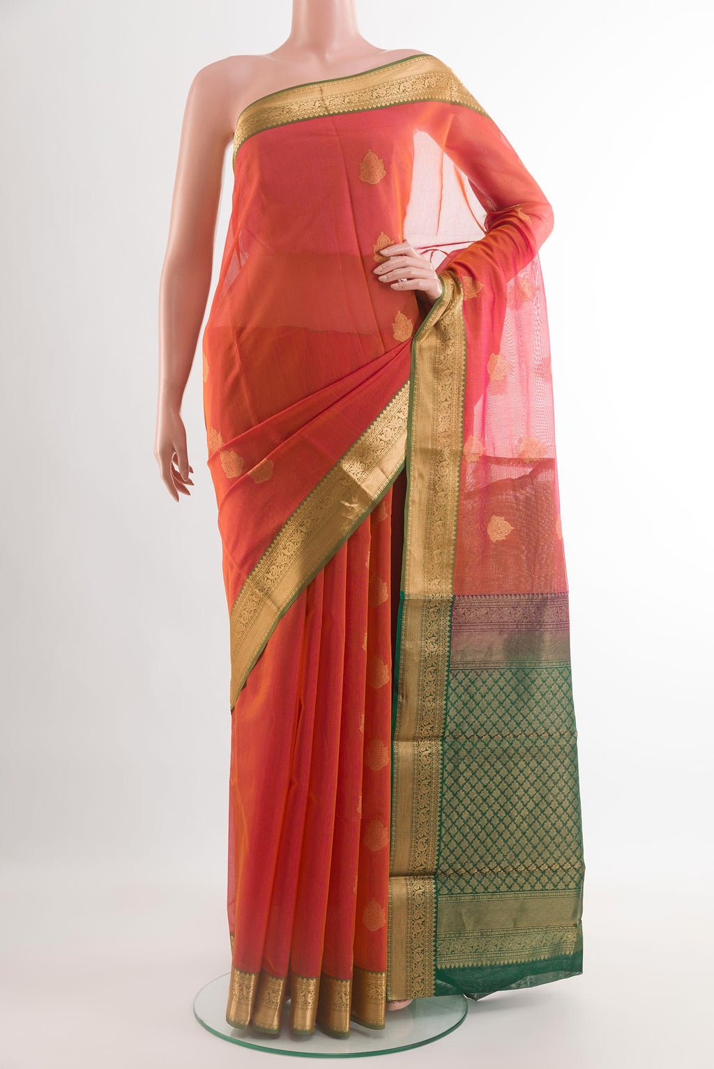 Brick Orange Silk Cotton Saree with Zari Butta on the body and Zari Border.  displayed on a mannequin