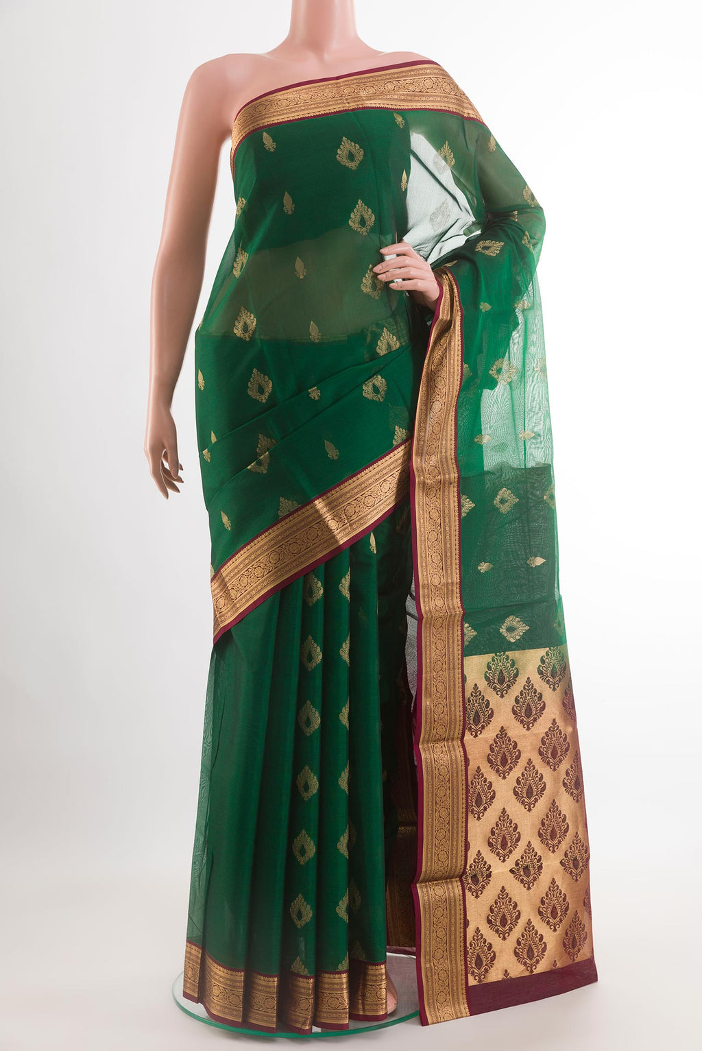 Green Blended Kora Cotton Saree with Zari Butta on the body and Zari Border.  displayed on a mannequin