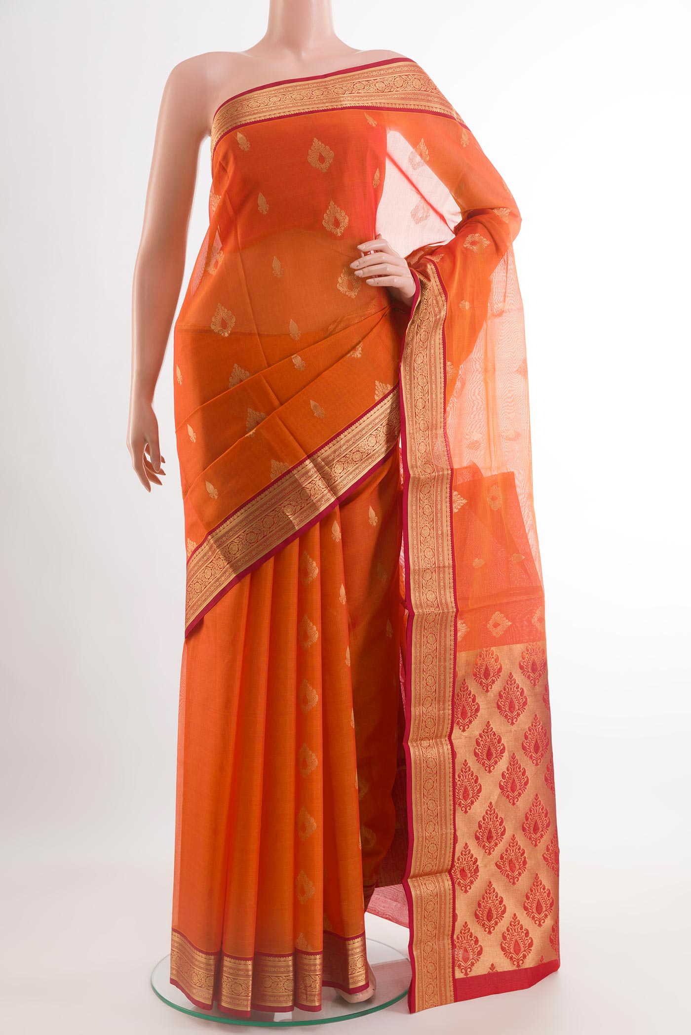 Orange Blended Kora Cotton Saree with Zari Butta on the body and Zari Border.  displayed on a mannequin