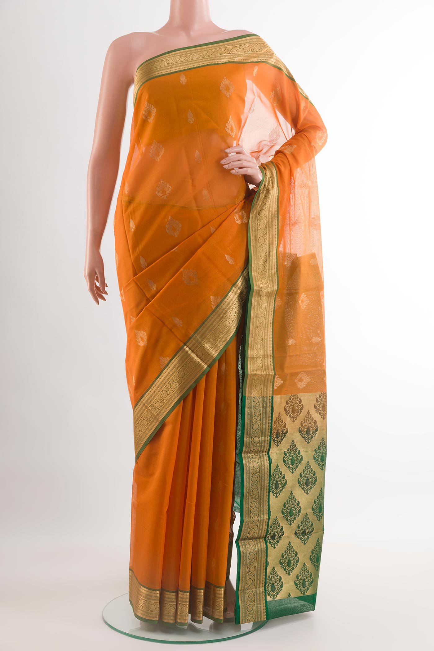 Mustard Silk Cotton Saree with Zari Butta on the body and Zari Border.  displayed on a mannequin