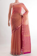 Peach Blended Kora Cotton Saree with Zari Butta on the body and Zari Border.  displayed on a mannequin