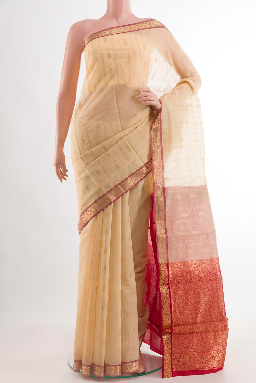 Beige Blended Kora Cotton Saree with Zari Butta on the body and Zari Border.  displayed on a mannequin