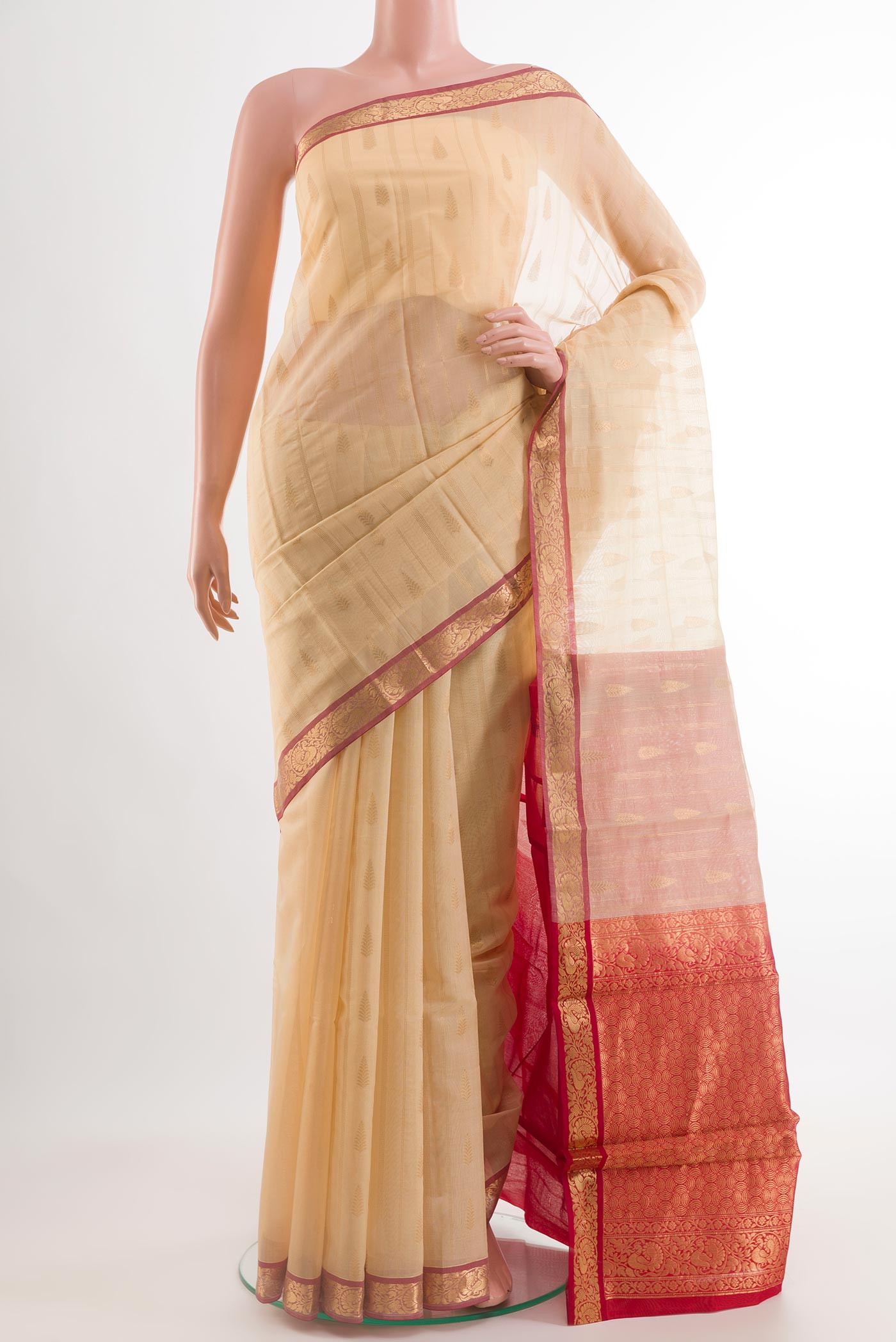 Beige Blended Kora Cotton Saree with Zari Butta on the body and Zari Border.  displayed on a mannequin