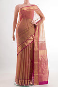 Peach Blended Kora Cotton Saree with Zari Butta on the body and Zari Border.  displayed on a mannequin